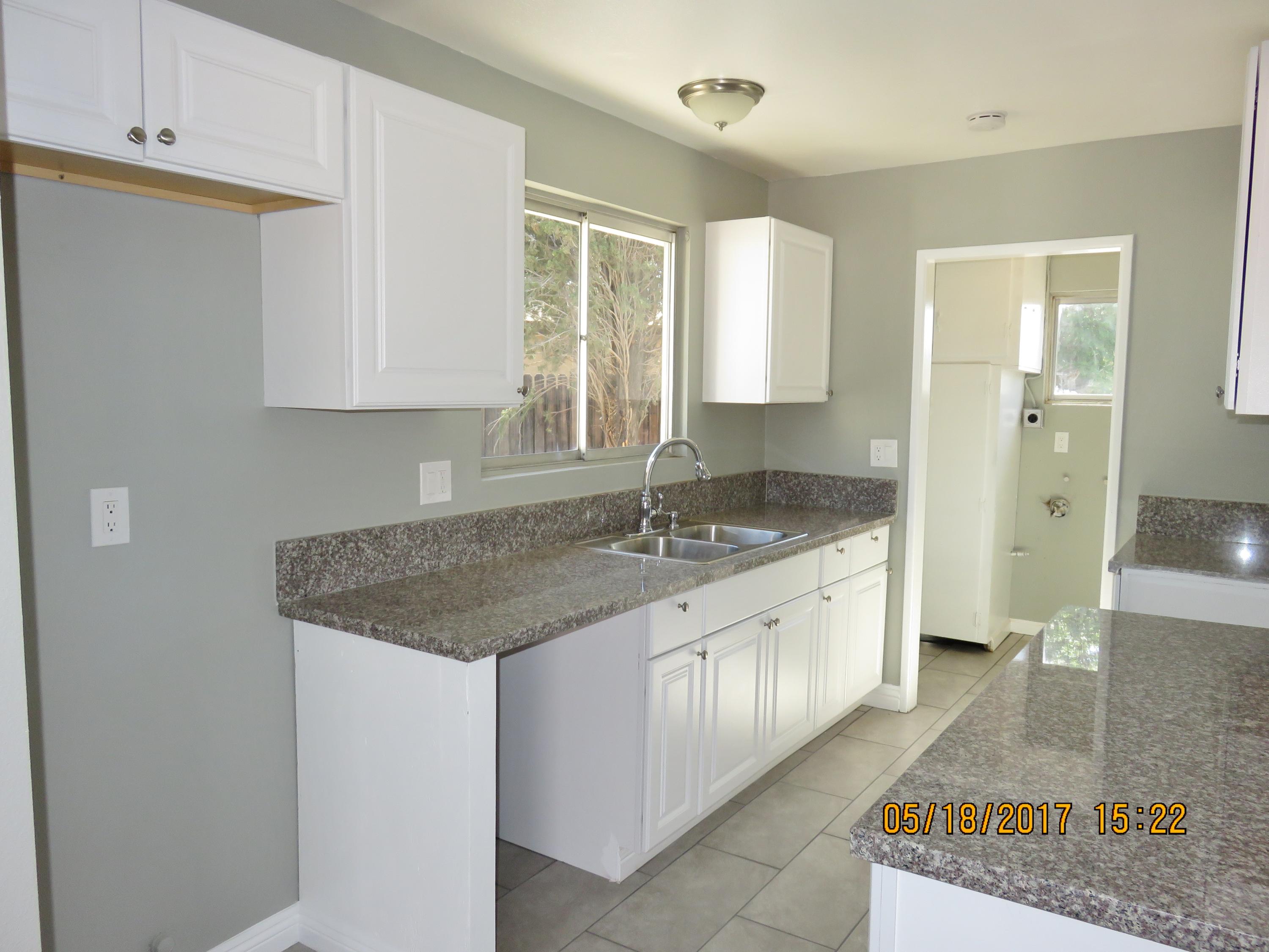 45402 Raysack Avenue Lancaster, CA 93535 - Photo 4 of 15 a bathroom with a granite countertop sink and a mirror