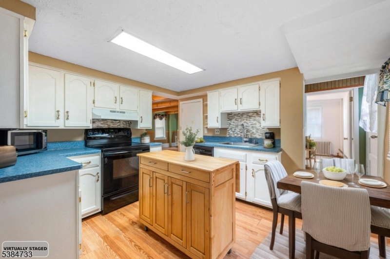 400 Quaker Church Road Randolph, NJ 07869 - Photo 16 of 34 a kitchen with stainless steel appliances granite countertop a stove a sink dishwasher a stove and white cabinets with wooden floor