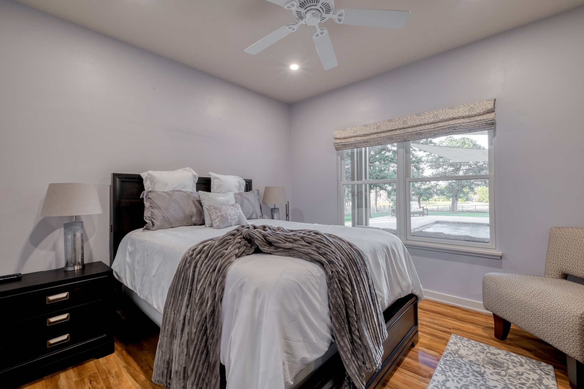 1474 County Rd B Lexington, TX 78947 - Photo 10 of 34 Hardwood floors and a large window illuminate this spacious sleeping sanctuary.