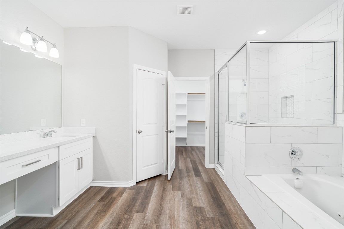 231 McCormick Street Columbus, TX 78934 - Photo 13 of 27 Primary Bathroom – Spa-like primary bath with dual vanities, expansive mirror, and modern lighting.