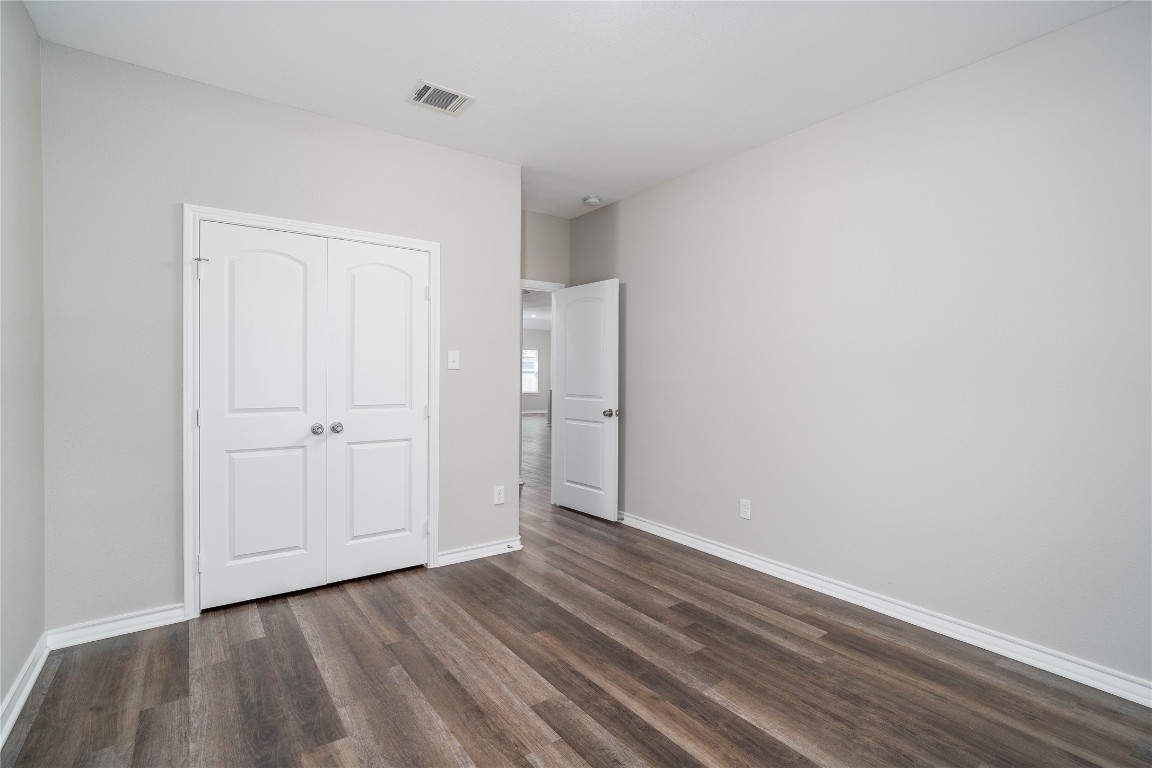 231 McCormick Street Columbus, TX 78934 - Photo 19 of 27 Bedroom – Spacious layout with ample wall space and a double-door closet, offering both comfort and functional storage.