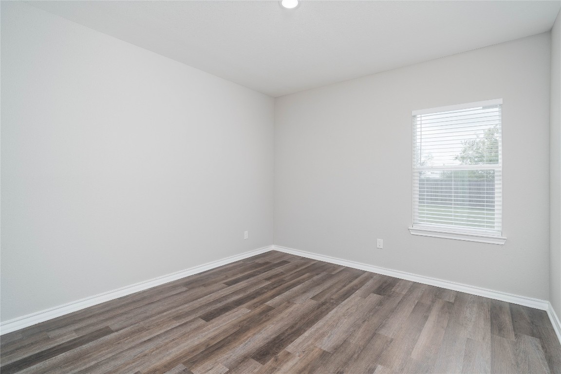 231 McCormick Street Columbus, TX 78934 - Photo 24 of 27 Bedroom – Generously sized bedroom with wide plank flooring, soft natural light, and a versatile layout to suit various needs.