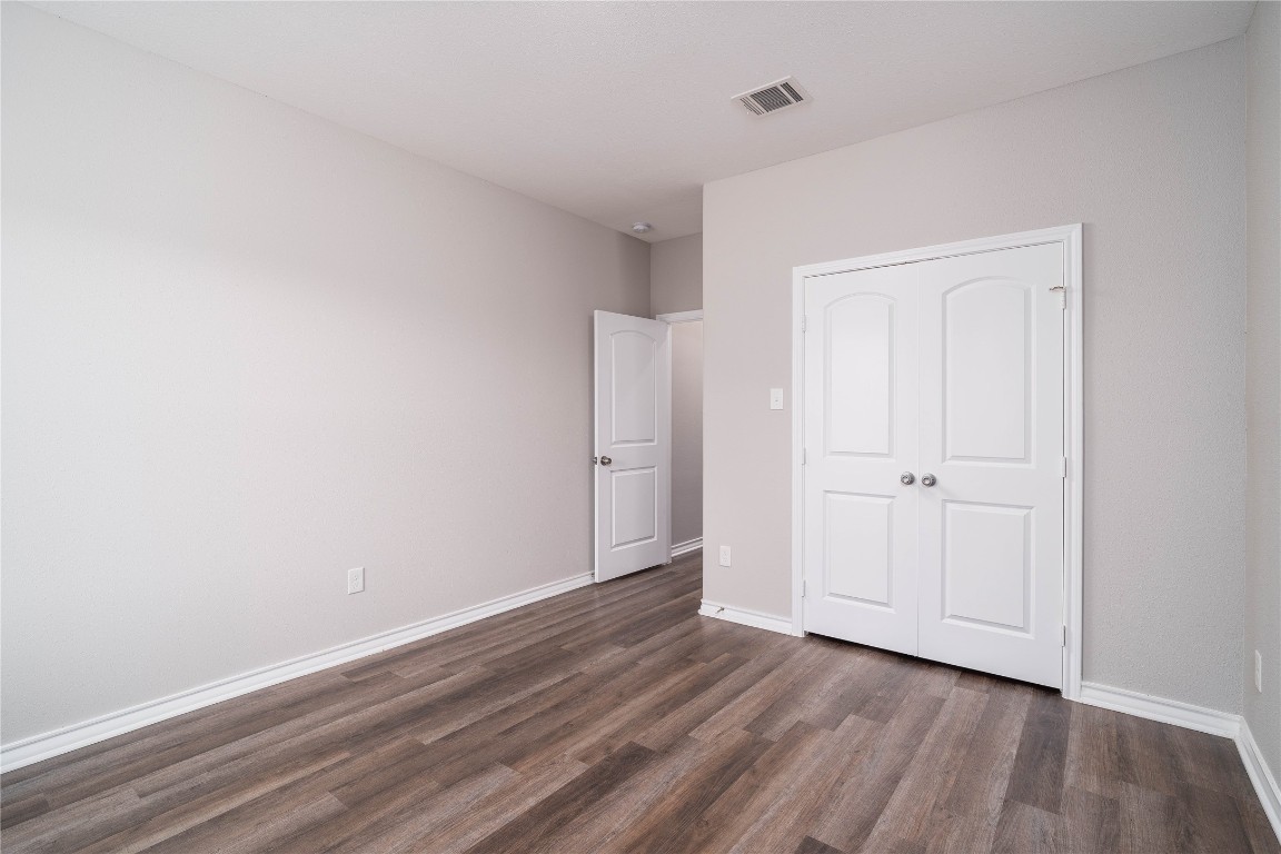 231 McCormick Street Columbus, TX 78934 - Photo 27 of 27 Bedroom – Another view of the bedroom highlighting the spacious floor plan, large closet, and easy access to adjacent living areas.