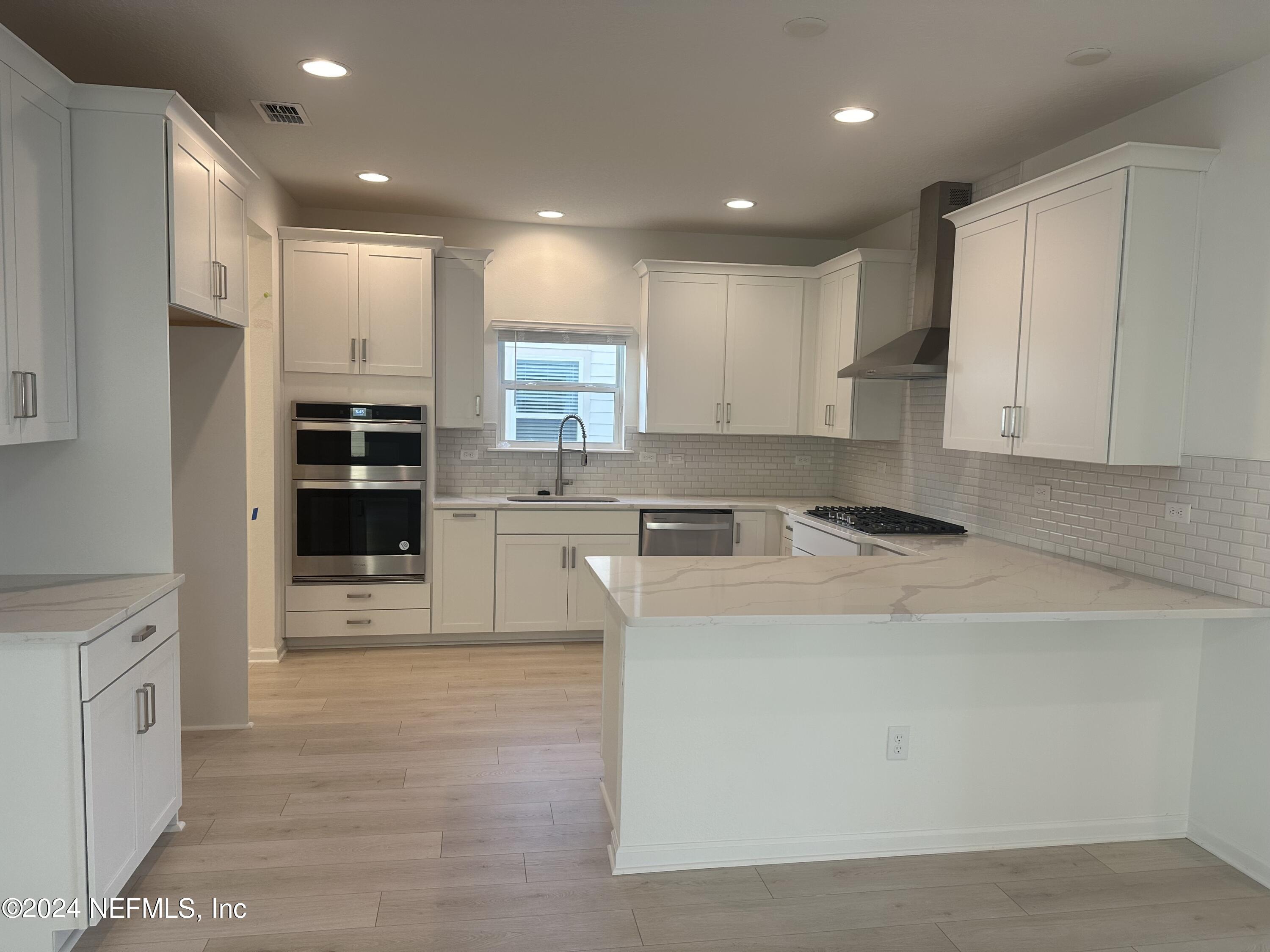 654 Stargaze Lane, Unit 77 St. Augustine, FL 32095 - Photo 3 of 5 a large kitchen with stainless steel appliances granite countertop a stove a sink and a refrigerator