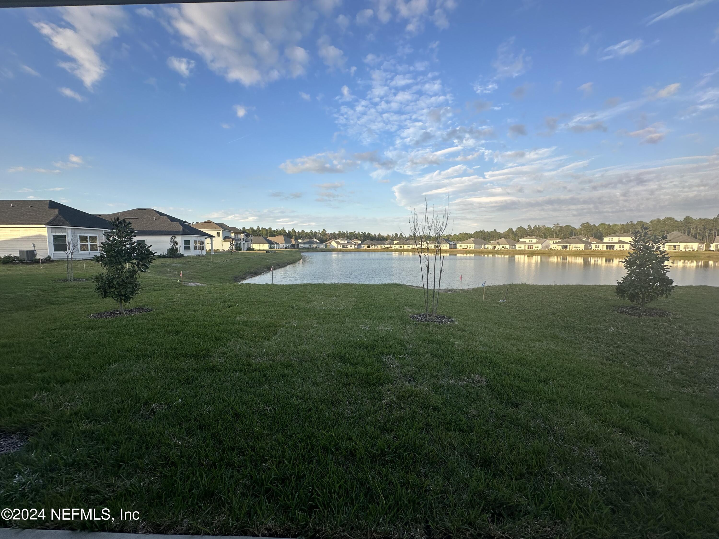 654 Stargaze Lane, Unit 77 St. Augustine, FL 32095 - Photo 5 of 5 a view of a lake with a big yard