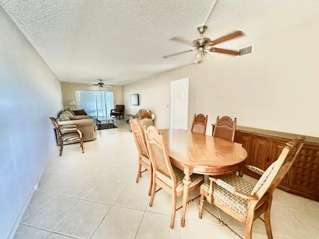 a dining room with furniture and a chandelier