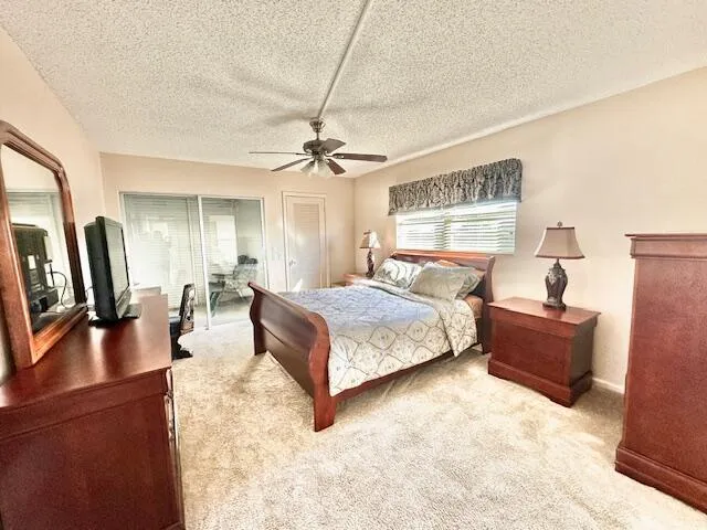 a spacious bedroom with a bed a couch and dresser