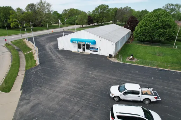 an aerial view of a house with swimming pool and garden