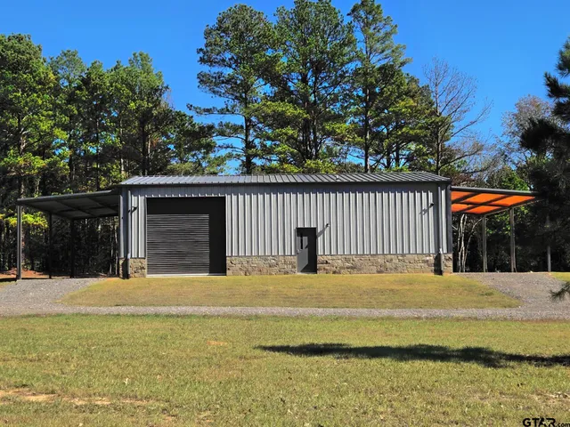 an aerial view of ocean and residential houses with outdoor space