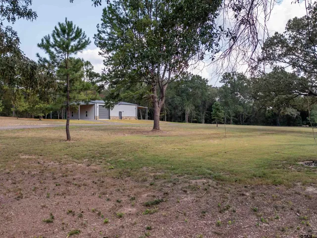an aerial view of a houses with a yard