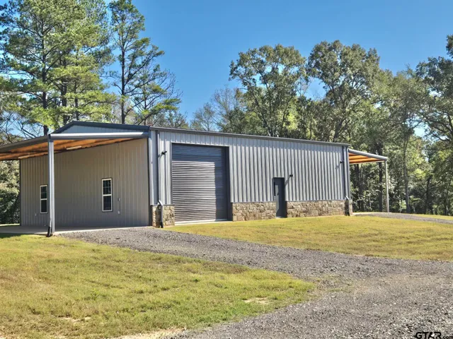 a kitchen with granite countertop a refrigerator sink and cabinets