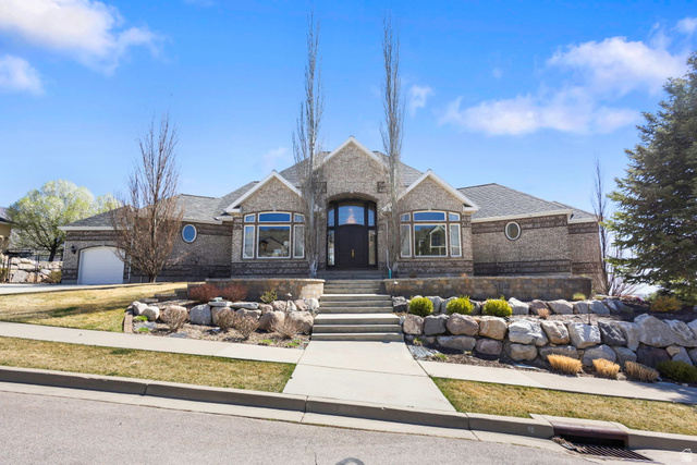 684 North Summit Way Alpine, UT 84004 - Photo 2 of 58 French country inspired facade featuring an attached garage, a shingled roof, brick siding, and driveway