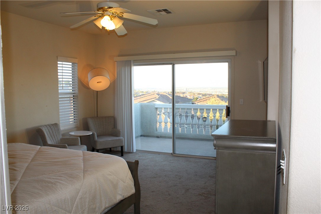 207 Priority Point Street Henderson, NV 89012 - Photo 16 of 38 Bedroom featuring carpet floors, multiple windows, access to outside, and a ceiling fan