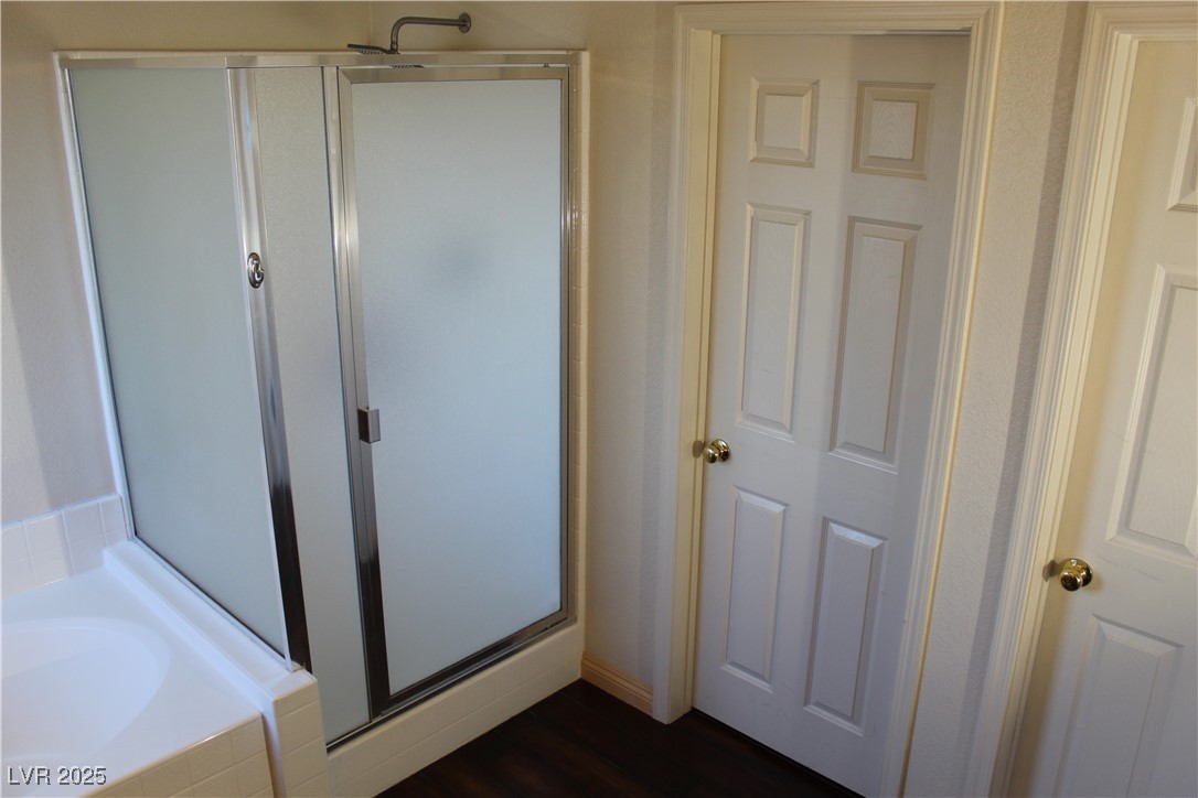 207 Priority Point Street Henderson, NV 89012 - Photo 23 of 38 Bathroom with a bath, a stall shower, and dark wood finished floors