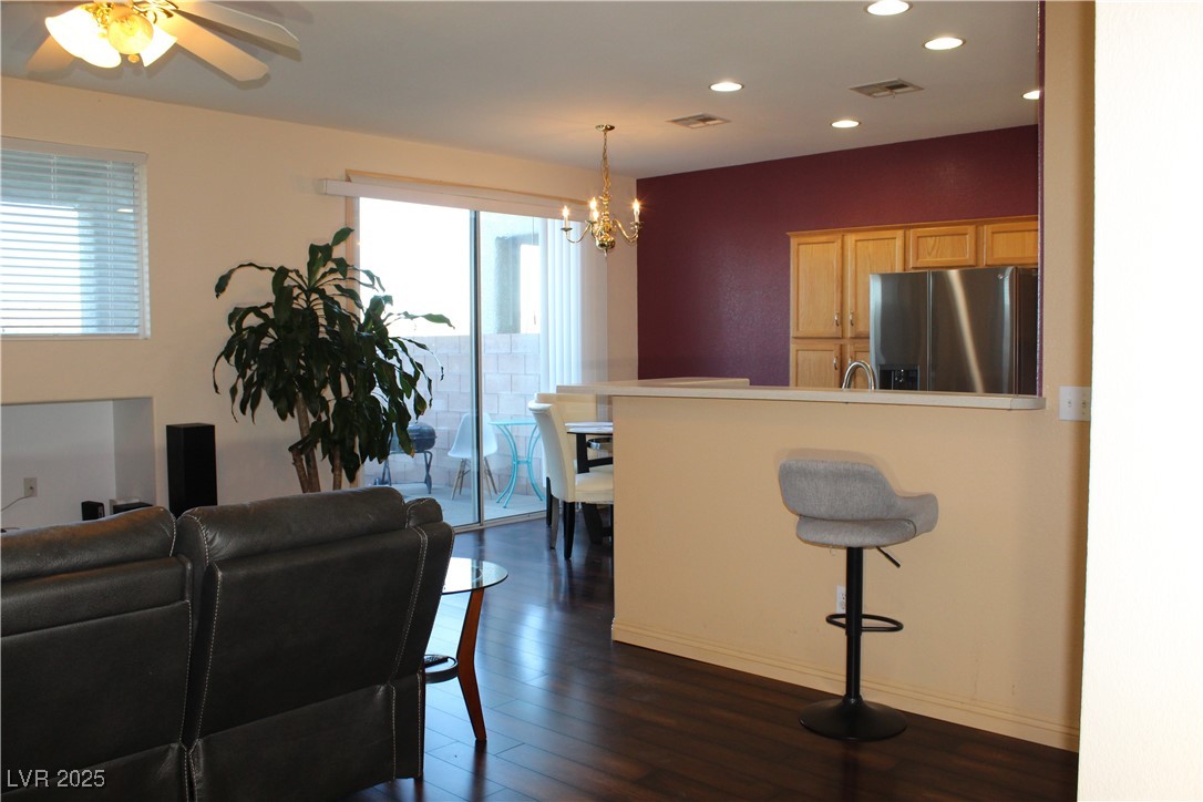 207 Priority Point Street Henderson, NV 89012 - Photo 5 of 38 Living room featuring dark wood finished floors, recessed lighting, a chandelier, and a ceiling fan