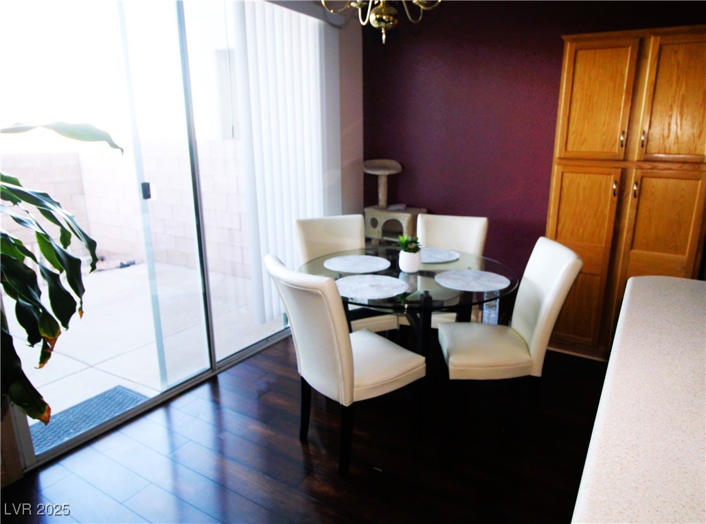 207 Priority Point Street Henderson, NV 89012 - Photo 7 of 38 Dining room featuring dark wood finished floors and a chandelier