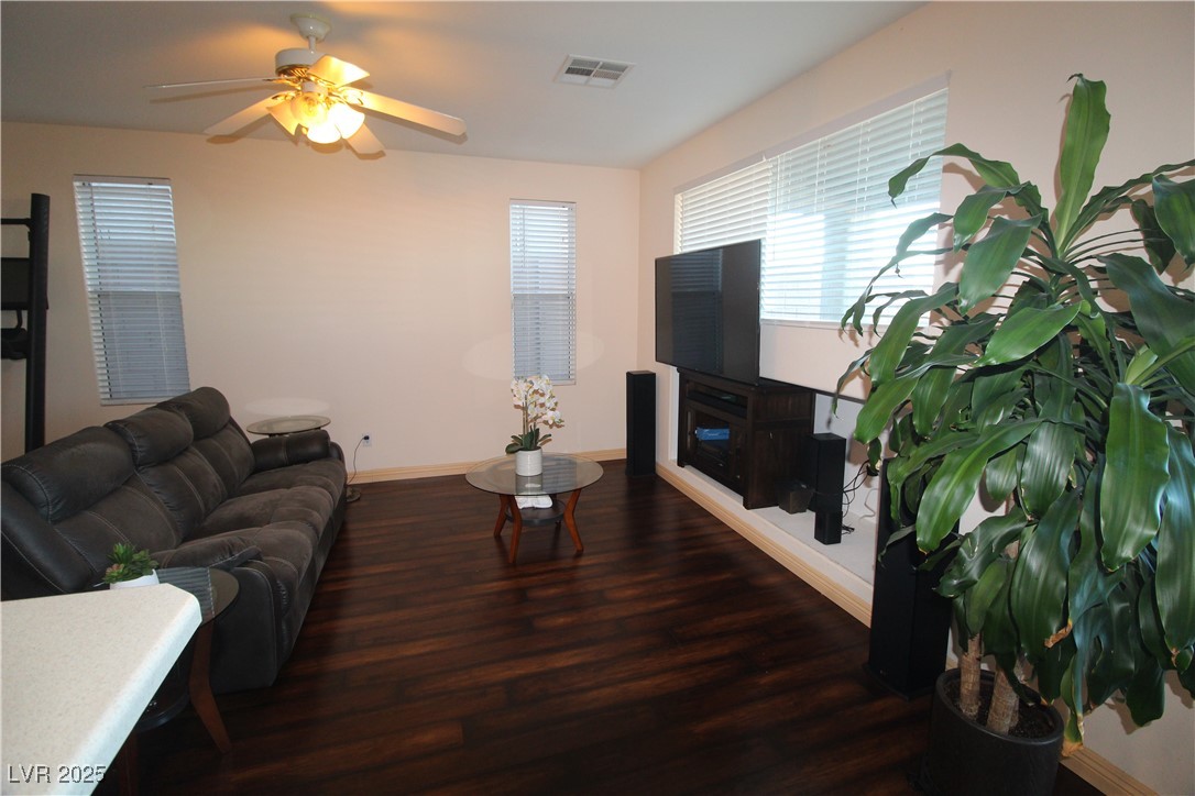 207 Priority Point Street Henderson, NV 89012 - Photo 10 of 38 Living area featuring dark wood-style floors and a ceiling fan