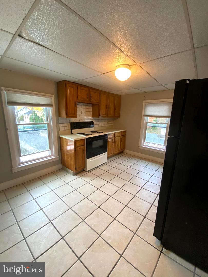 64 South Evans Street, Unit 3 Pottstown, PA 19464 - Photo 3 of 15 a kitchen with stainless steel appliances granite countertop a stove a sink and a refrigerator