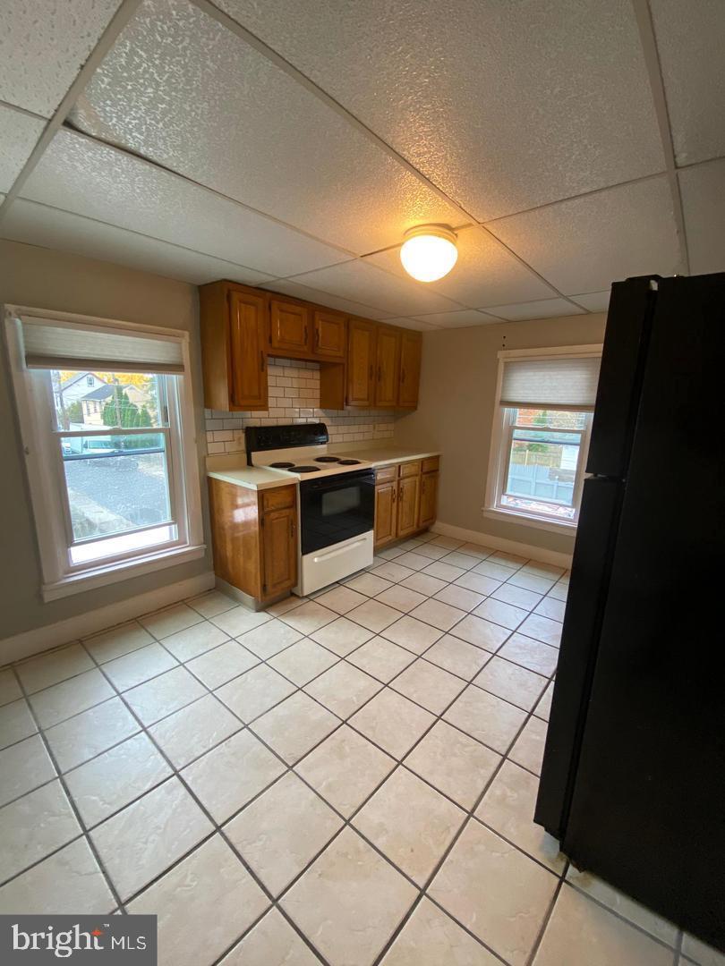64 South Evans Street, Unit 3 Pottstown, PA 19464 - Photo 3 of 15 a kitchen with stainless steel appliances granite countertop a stove a sink and a refrigerator