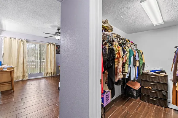 a bathroom with a granite countertop sink toilet a mirror a bathtub and shower