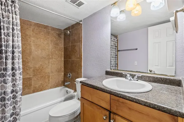 a bathroom with a sink toilet tub and shower