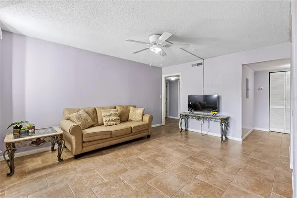 a living room with furniture and a floor to ceiling window