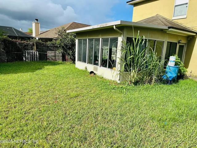 a view of a house with a yard and plants