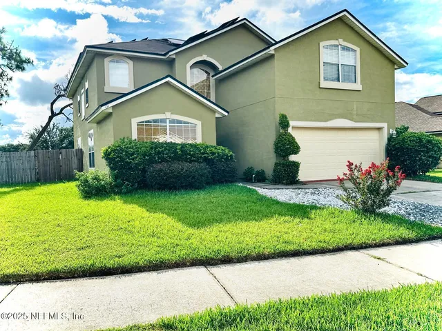 a front view of a house with a yard