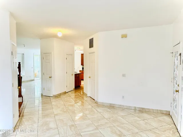 a view of a storage & utility room with refrigerator