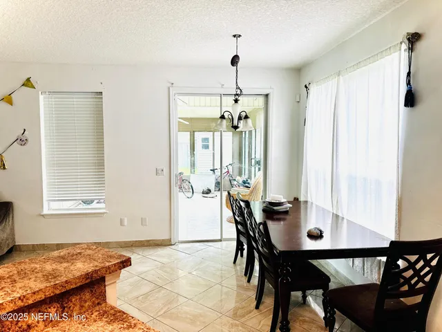 a view of a dining room with furniture and window