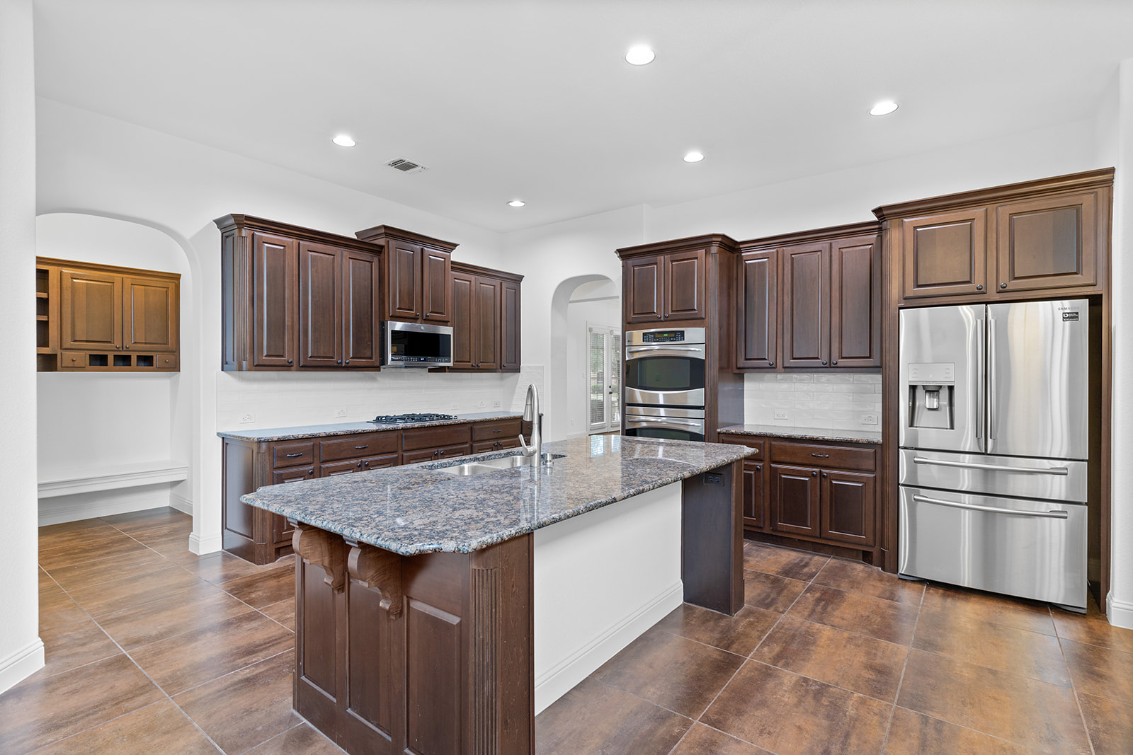 114 North Saddle Ridge Drive Cedar Park, TX 78613 - Photo 11 of 40 a kitchen with stainless steel appliances granite countertop a refrigerator a stove a sink and a microwave