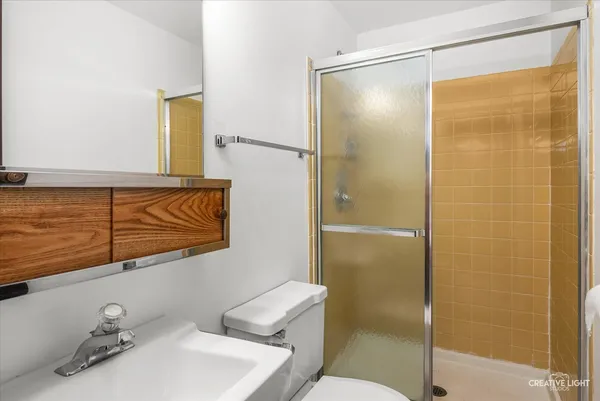 a bathroom with a shower and a sink