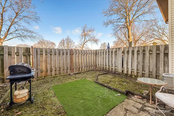 a view of a chair and table in backyard