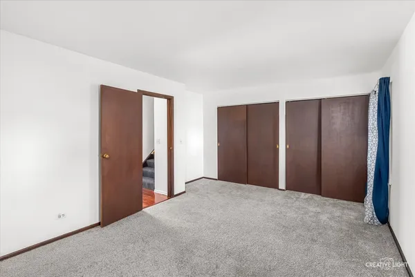 a view of an empty room with closet area