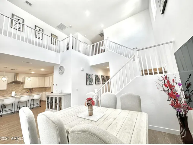 a bedroom with a large bed and a potted plant