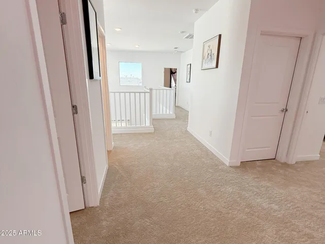 a view of a hallway to rooms