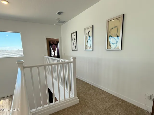 a view of staircase with wooden floor and a window