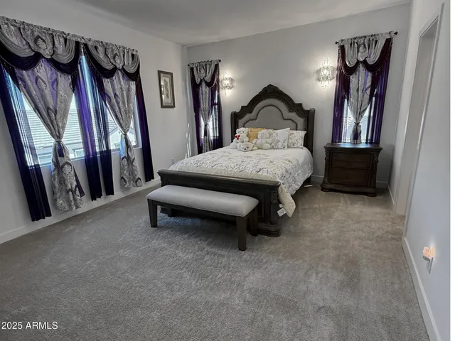 a spacious bedroom with a bed and a window