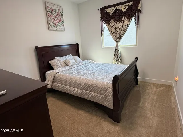 a bed sitting in a bedroom next to a window