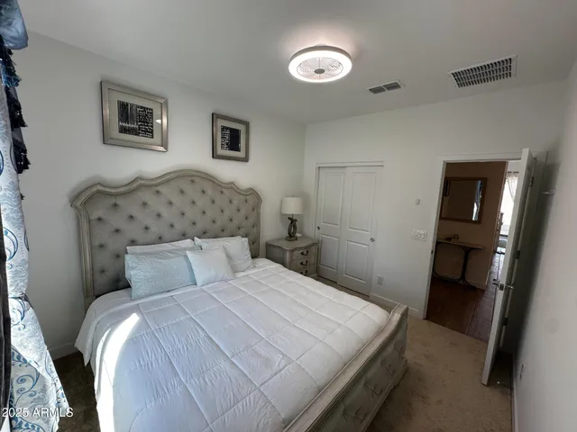 a bedroom with a bed and a mirror