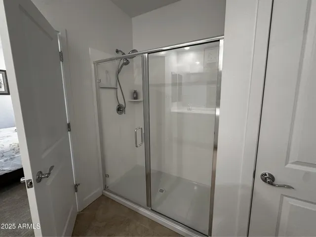 a bathroom with a glass shower door