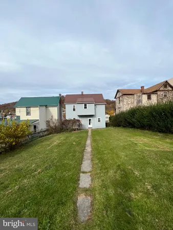 a view of a big house with a big yard