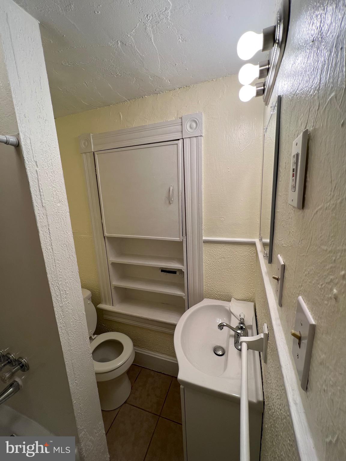 906 Lemon Street Johnstown, PA 15902 - Photo 8 of 13 a bathroom with a sink a toilet and shower