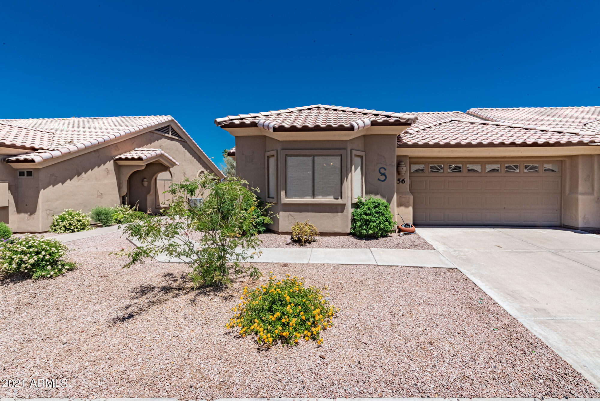 5830 East McKellips Road, Unit 56 Mesa, AZ 85215 - Photo 1 of 47 a front view of a house with garden