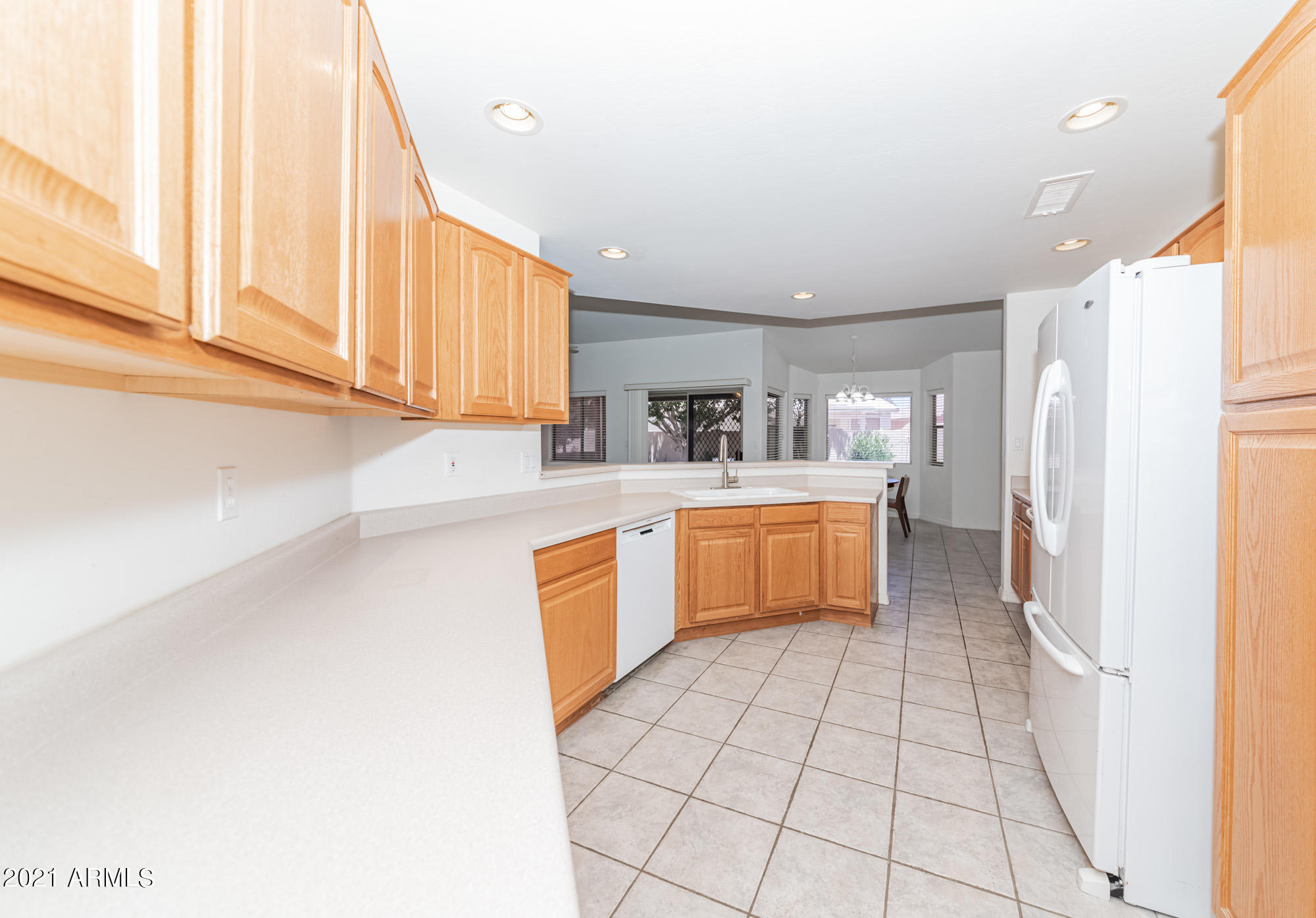 5830 East McKellips Road, Unit 56 Mesa, AZ 85215 - Photo 12 of 47 a kitchen with stainless steel appliances granite countertop a stove a sink and a refrigerator