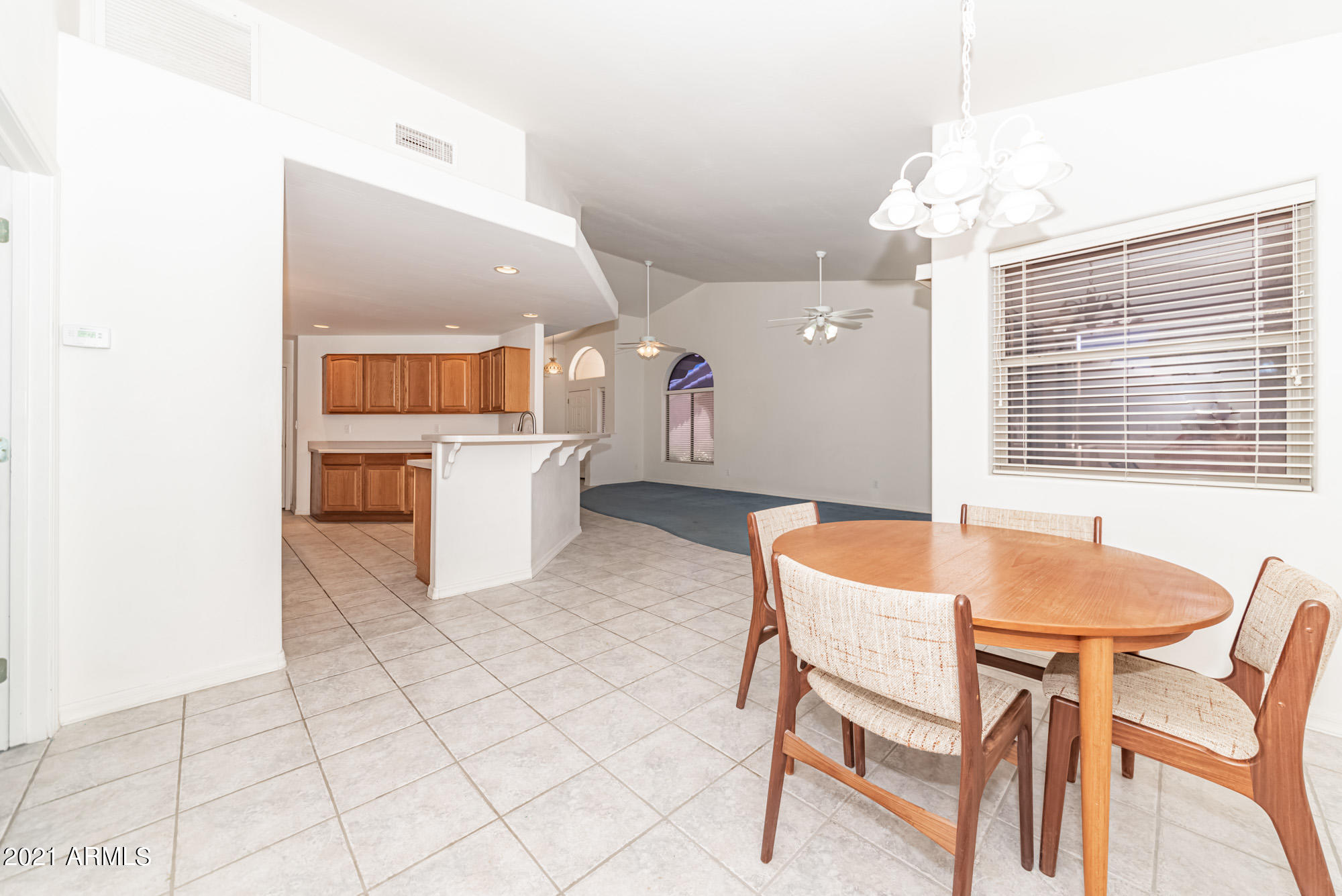 5830 East McKellips Road, Unit 56 Mesa, AZ 85215 - Photo 15 of 47 a kitchen with a table and chairs