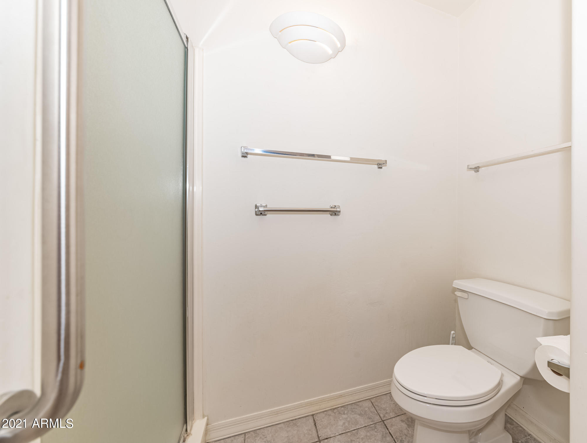 5830 East McKellips Road, Unit 56 Mesa, AZ 85215 - Photo 23 of 47 a white toilet sitting next to a shower
