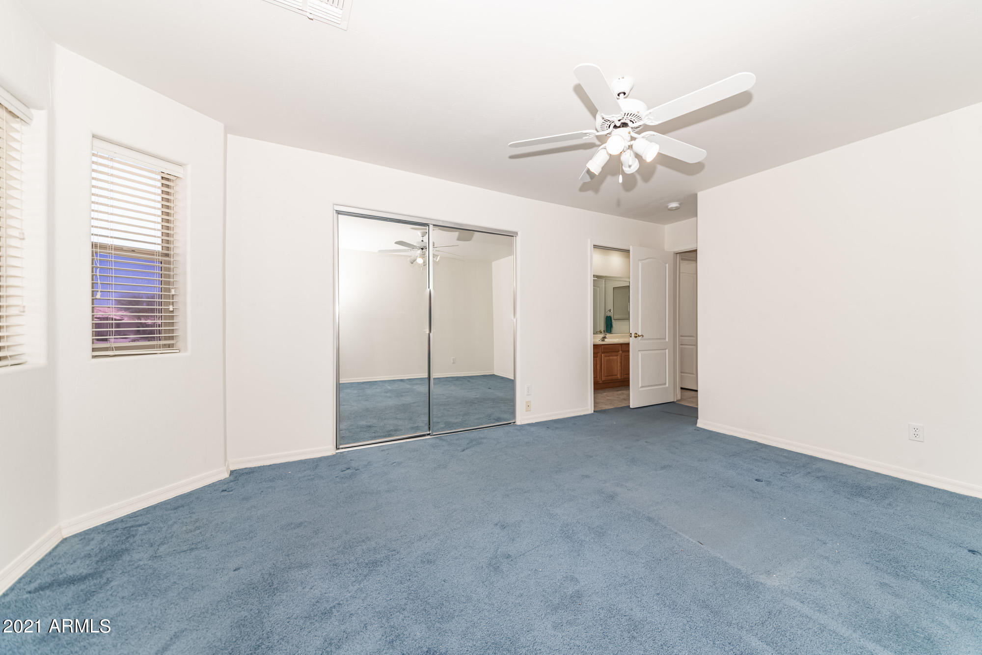 5830 East McKellips Road, Unit 56 Mesa, AZ 85215 - Photo 26 of 47 a view of an empty room with a ceiling fan