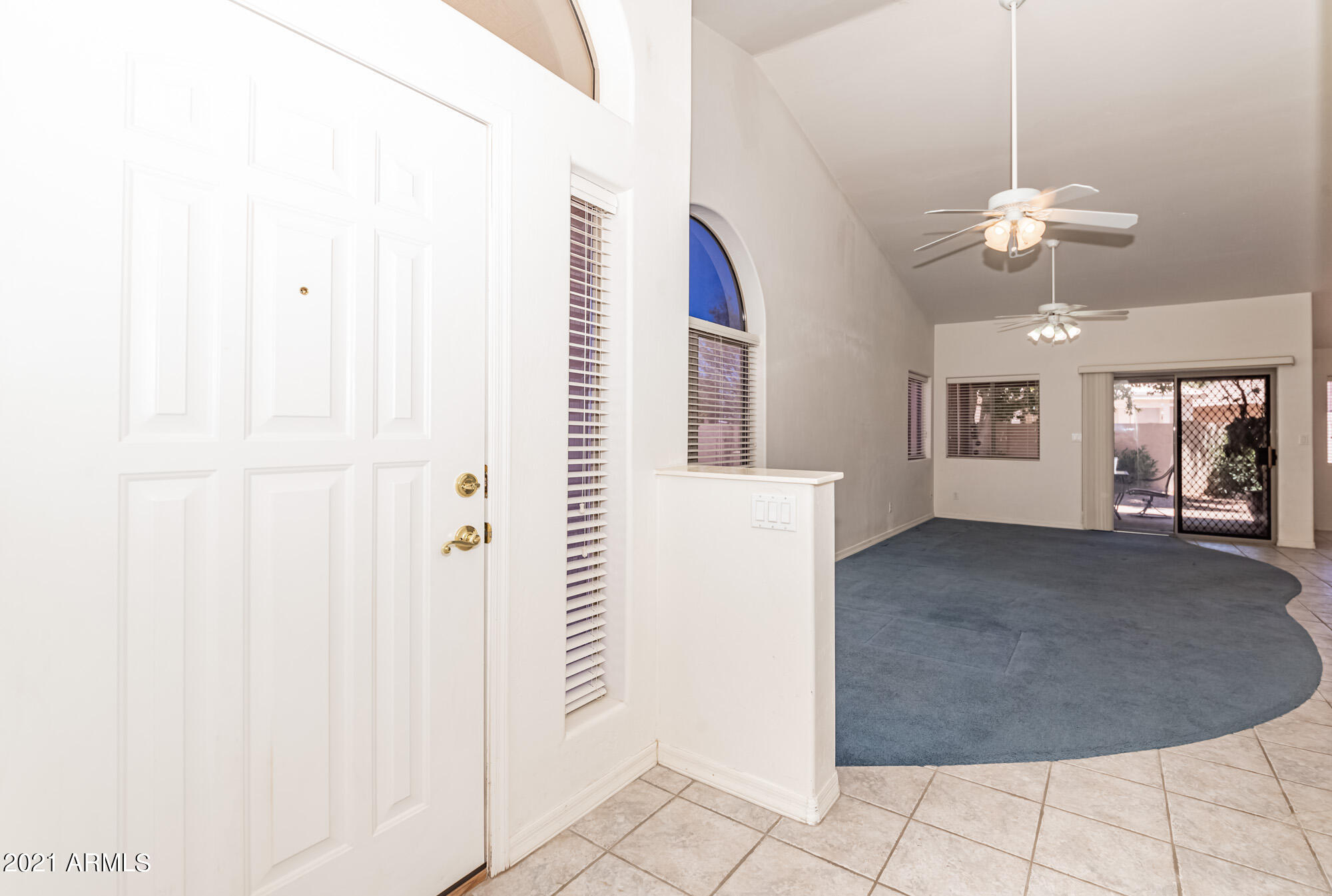 5830 East McKellips Road, Unit 56 Mesa, AZ 85215 - Photo 4 of 47 a view of a livingroom with a chandelier fan and windows