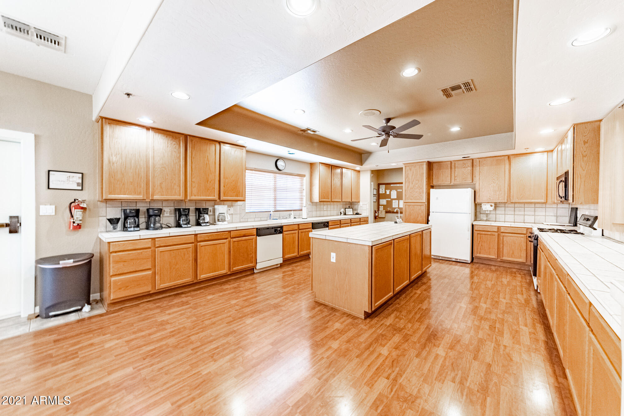 5830 East McKellips Road, Unit 56 Mesa, AZ 85215 - Photo 42 of 47 a large kitchen with a lot of counter top space a sink a window and stainless steel appliances